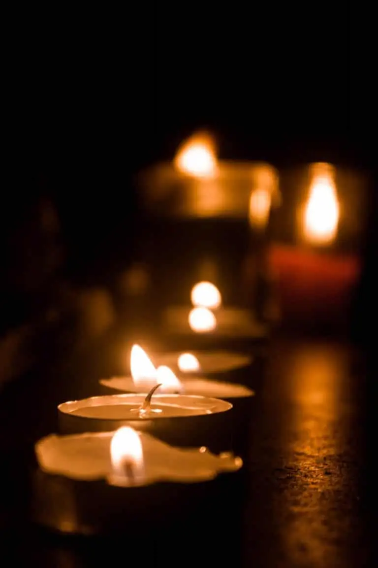 An image of many candles lit in a dark room representing out Christmas Eve Candlelight Service called Christmas in Gold Canyon.
