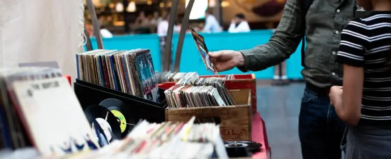 Image of people looking through records representing the Superstition Swap and Sell in Gold Canyon, AZ.