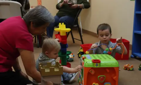Image of children playing with a nursery teacher at Superstition Foothills Baptist Church which is a church in Gold Canyon, AZ.