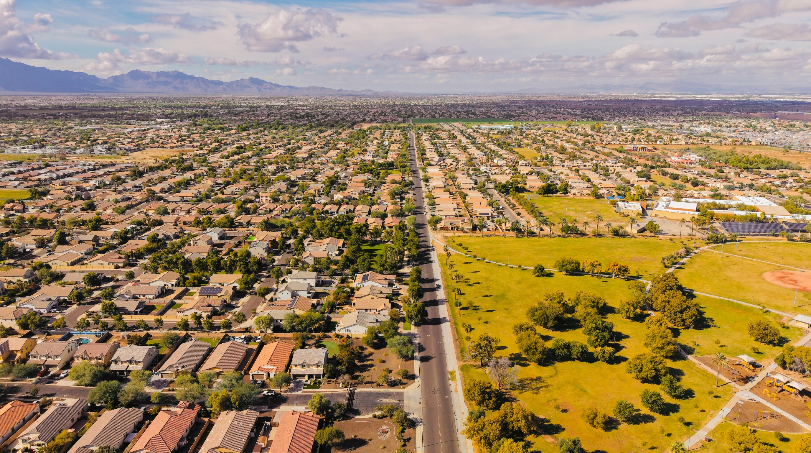 East Mesa neighborhoods aerial with Superstition Mountains East Mesa neighborhoods aerial with the Superstition Mountains in the background — Gold Canyon and Superstition Foothills Baptist Church are just beyond those mountains
